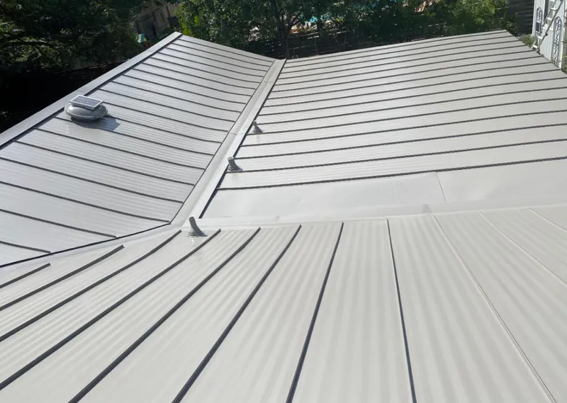 Solar attic fan installed on a metal roof for Roof Ventilation in Takoma Park
